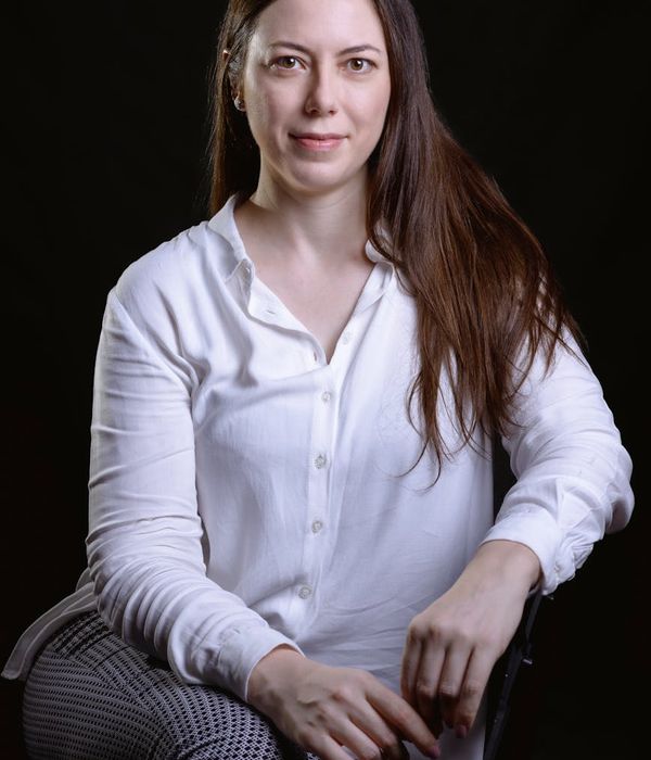 Woman in a dynamic but gentle cardio pose against a dark, stylish background.